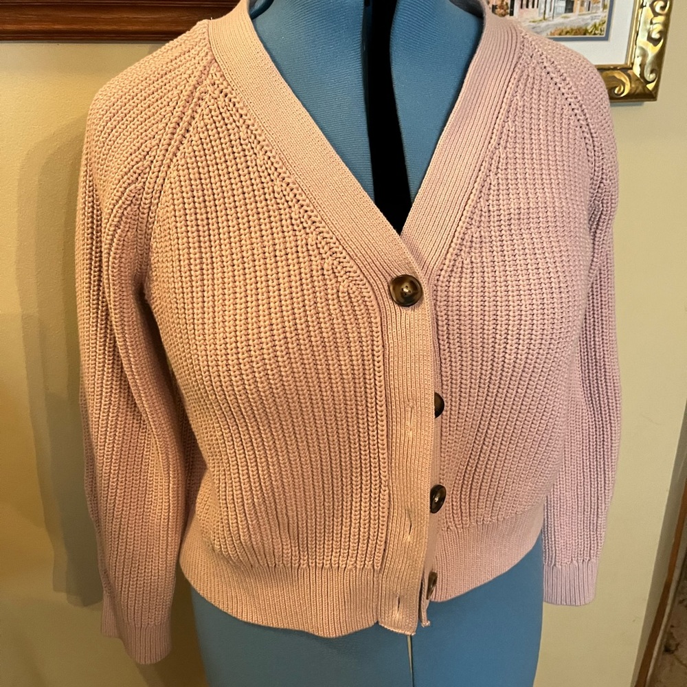 Pale pink sweater in an almost cropped style